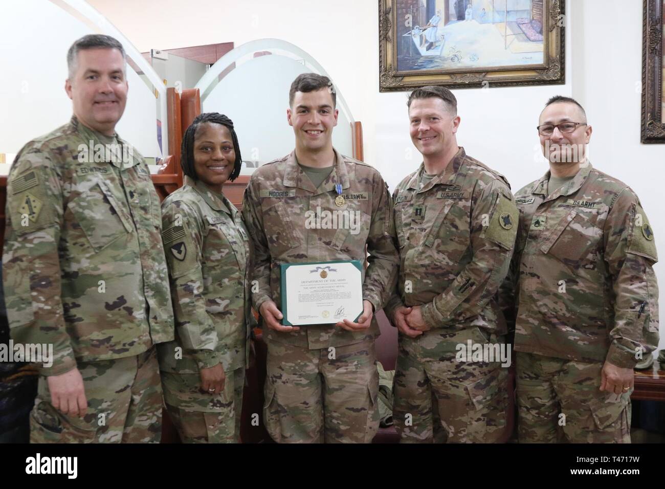 Lt. Col. Robert Edwards, Sgt. First Class Wanda Cook, Cpt. Eric Nowlen, Staff Sgt. Dean Rodriquez ,184th Sustainment Command, stand with one of their own, Sgt. Christopher Hodges, after he was selected as noncommissioned officer division runner up in the 1st Theater Sustainment Command's Best Warrior Competition during an awards ceremony at Camp Arifjan, Kuwait, March 14, 2019. Stock Photo