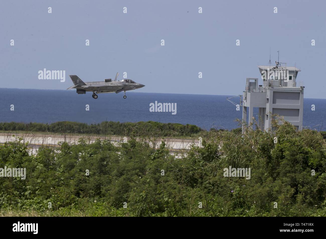 An F-35B Lightning II fighter aircraft with Marine Fighter Attack Squadron 121 lands at Ie Shima Training Facility during simulated Expeditionary Advanced Base Operations, March 14, 2019. Marines with the 31st Marine Expeditionary Unit are conducting simulated EABO in a series of dynamic training events to refine their ability to plan, rehearse and complete a variety of missions. During EABO, the 31st MEU partnered with the 3rd Marine Division, 3rd Marine Logistics Group and 1st Marine Aircraft Wing, and airmen with the U.S. Air Force 353rd Special Operations Group, planning and executing trai Stock Photo