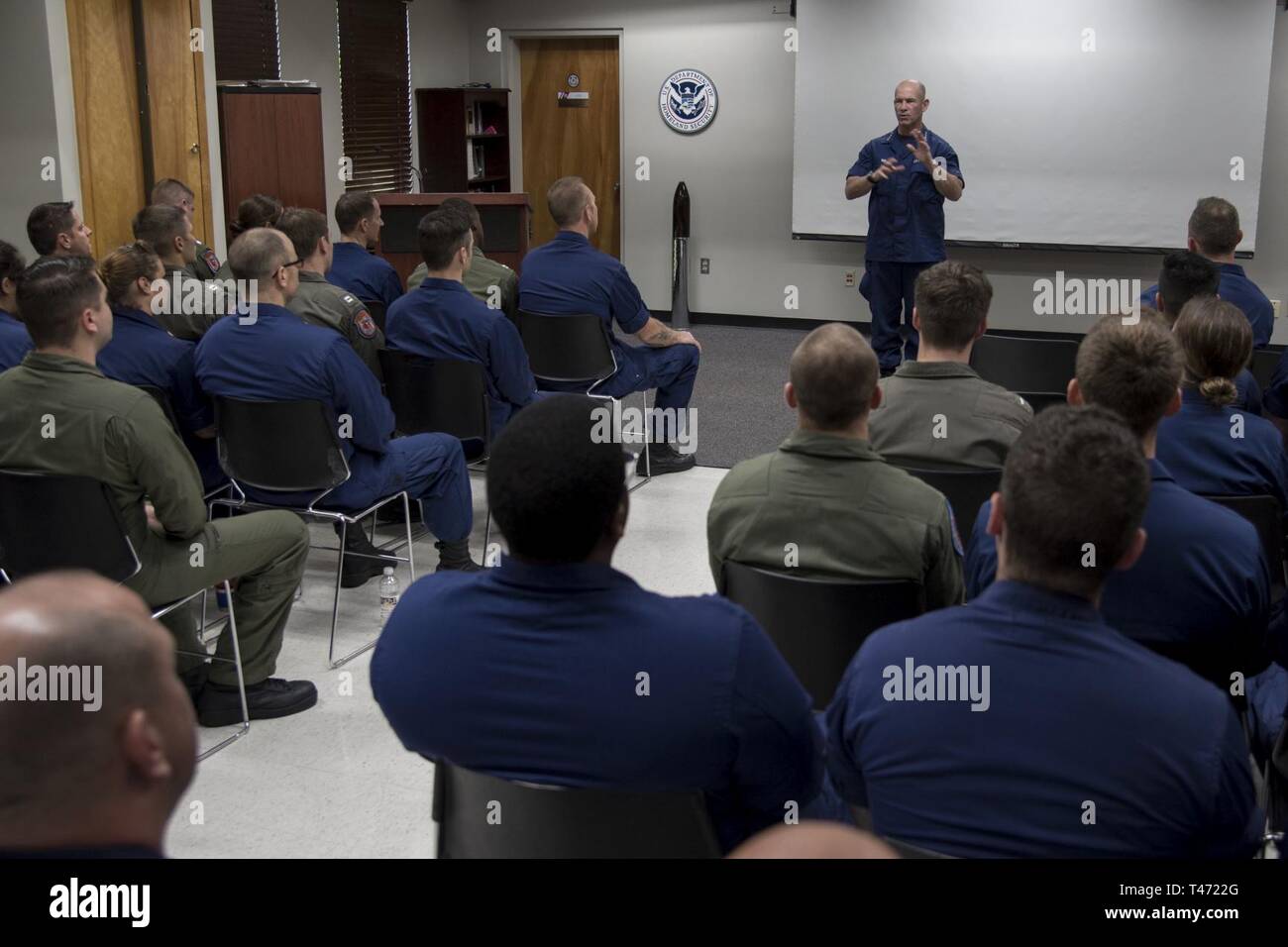Adm. Charles W. Ray, vice commandant of the Coast Guard, speaks to Coast Guard members during a unit visit at Coast Guard Air Station New Orleans, Thursday, March 14, 2019. Air Station New Orleans supports a wide range of Coast Guard operations to include search and rescue, law enforcement, port security and marine environmental protection. Coast Guard Stock Photo