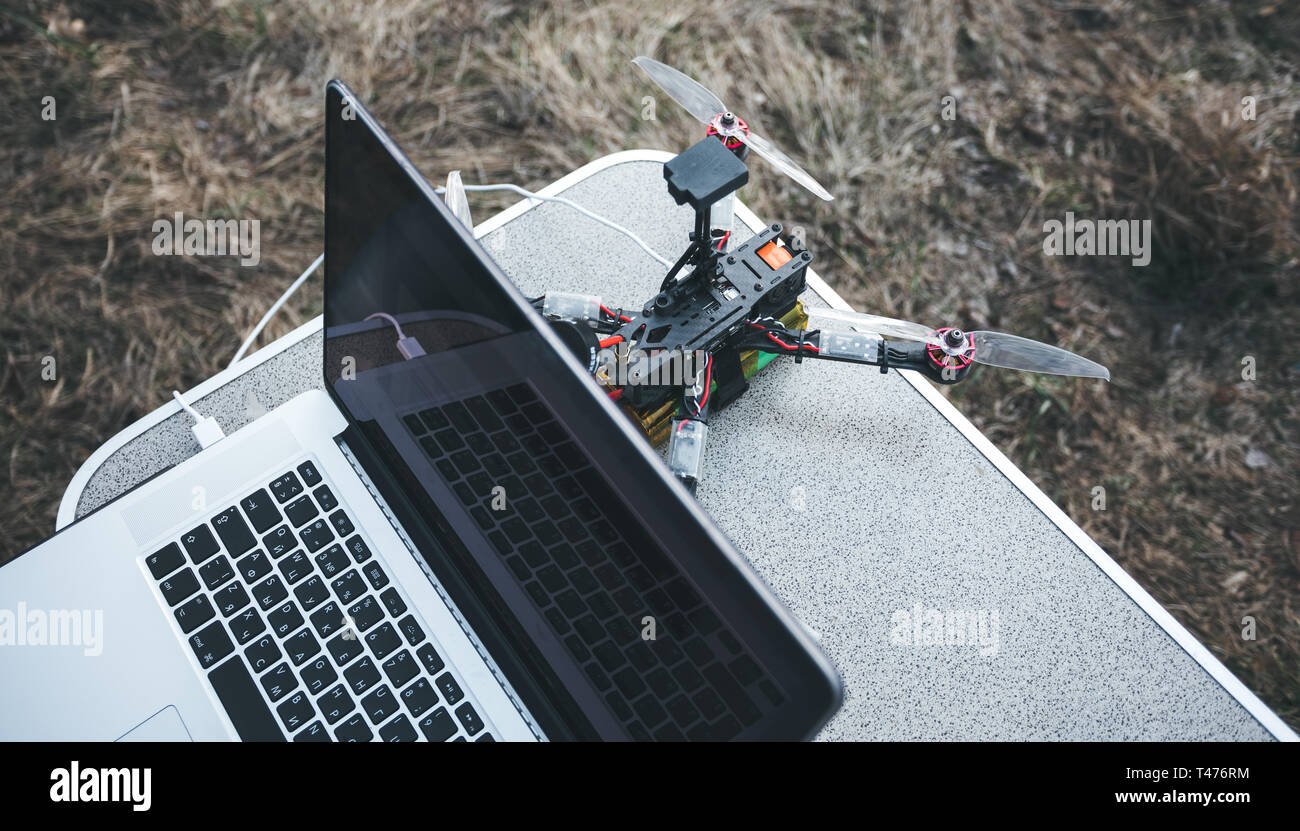 FPV drone lies on the table near the laptop and control panel Stock Photo -  Alamy