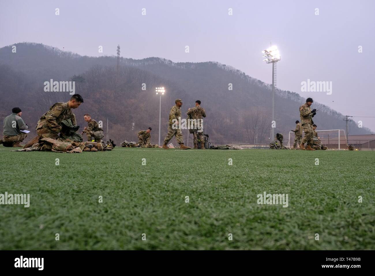 Competitors from the 210th Field Artillery Brigade 2019 Best Warrior Competition layout their gear at Schoonover Bowl following the eight-mile ruck march, Camp Casey, Republic of Korea, March 12, 2019. The ruck march began this year’s competition with 24 Soldiers competing for first place in the following ranks: junior enlisted, noncommissioned officer, warrant officer, commissioned officer, and Korean Augmentation to the United States Army (KATUSA).The competition served as a valuable training experience, and the winners will advance to the 2nd Infantry Division Best Warrior Competition April Stock Photo