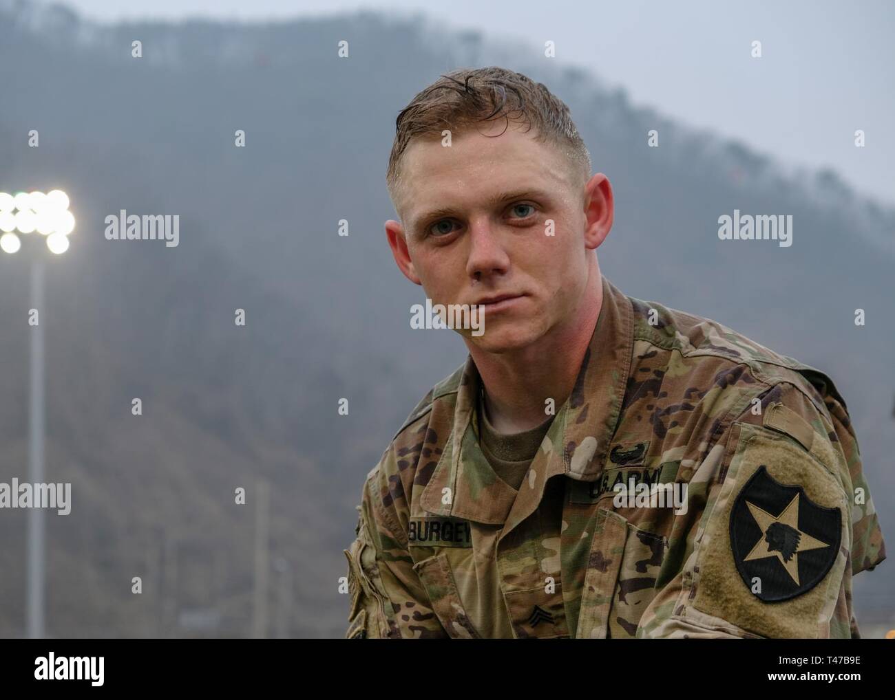 Sgt. Austin Amburgey, fire control specialist, assigned to Battery A., 1st Battalion, 38th Field Artillery Regiment, 210th Field Artillery Brigade (FAB), pauses to pose for a quick photograph following the eight-mile ruck march during the 210th FAB 2019 Best Warrior Competition, Camp Casey, Republic of Korea, March 12, 2019. Amburgey was clearly exhausted but ready to keep moving through the events in the competition. The ruck march began this year’s competition with 24 Soldiers competing for first place in the following ranks: junior enlisted, noncommissioned officer, warrant officer, commiss Stock Photo
