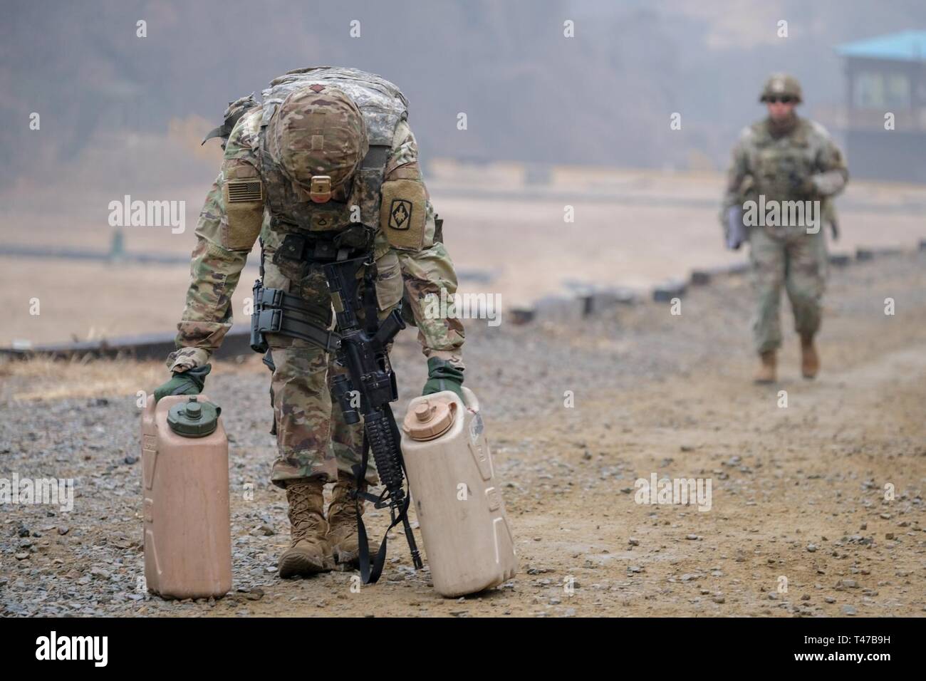 Pfc. Gilberto Ramirez, fire control specialist, B., assigned to 3rd Battalion, 13th Artillery Regiment, 75th Field Artillery Brigade (FAB) catch his breath after ascending a hill with two