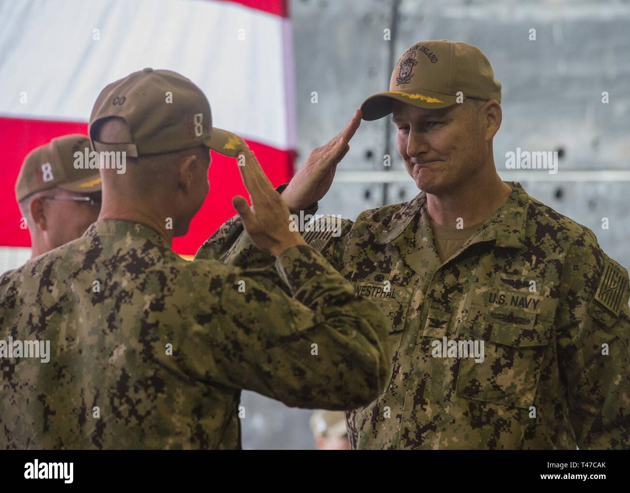 DIEGO (March 15, 2019) — Capt. David Oden, the outgoing commanding officer of the amphibious assault ship USS Makin Island (LHD 8), turns over command to Capt. Christopher Westphal during a change of command ceremony held in the ship’s well deck. Makin Island, homeported in San Diego, is conducting a depot-level maintenance availability. Stock Photo