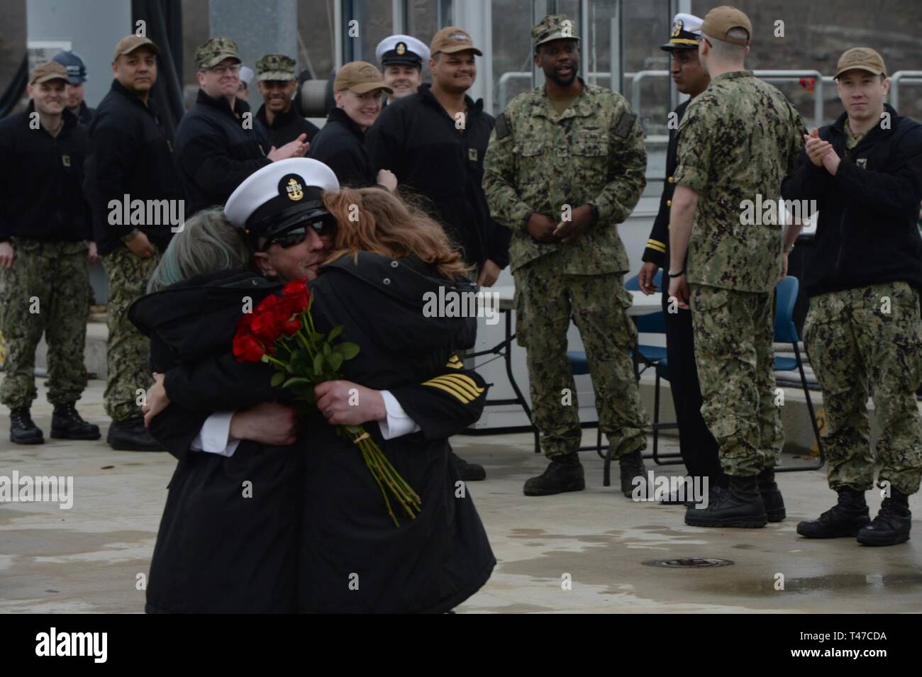GROTON, Conn. (Mar. 15, 2019) Chief Electronics Technician Submarine Communications Eric Whitaker greets his two daughters, with the traditional first hug during a homecoming celebration for the Los Angeles-class, fast-attack submarine USS Providence  (SSN 719) at Naval Submarine Base New London in Groton, Conn. Providence is returning from the European Command Area of Responsibility where they executed the Chief of Naval Operations' Maritime Strategy in supporting national security interests and Maritime Security Operations. Stock Photo