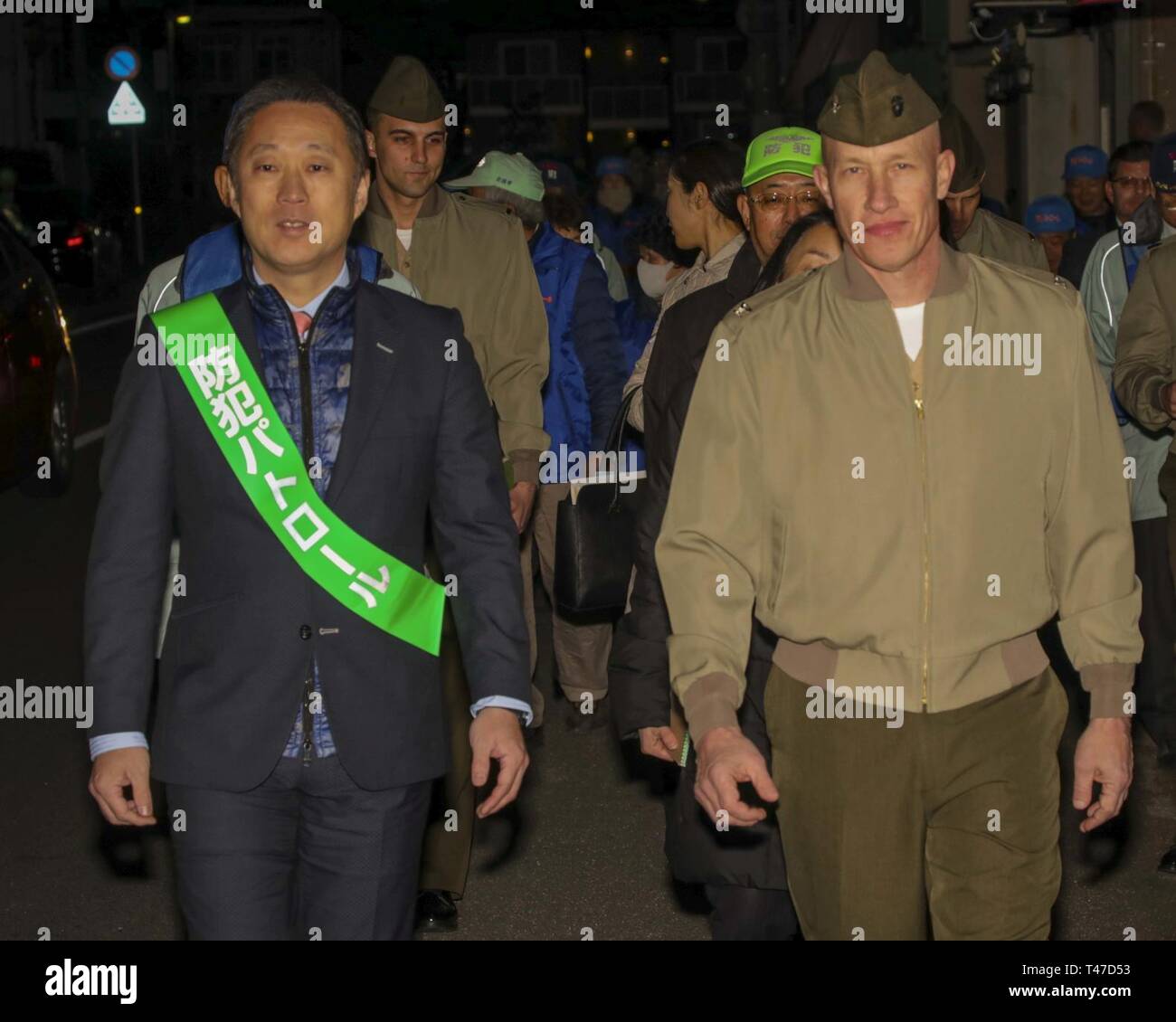 Yoshihiko Fukuda, left, the mayor of Iwakuni City, and U.S. Marine Corps Col. Richard Fuerst, commanding officer of Marine Corps Air Station Iwakuni, participate in the 10th Joint Leadership Walk in Iwakuni City, March 15, 2019. The walk consisted of touring popular local areas where they spoke to business owners as well as Japanese and American customers. Stock Photo