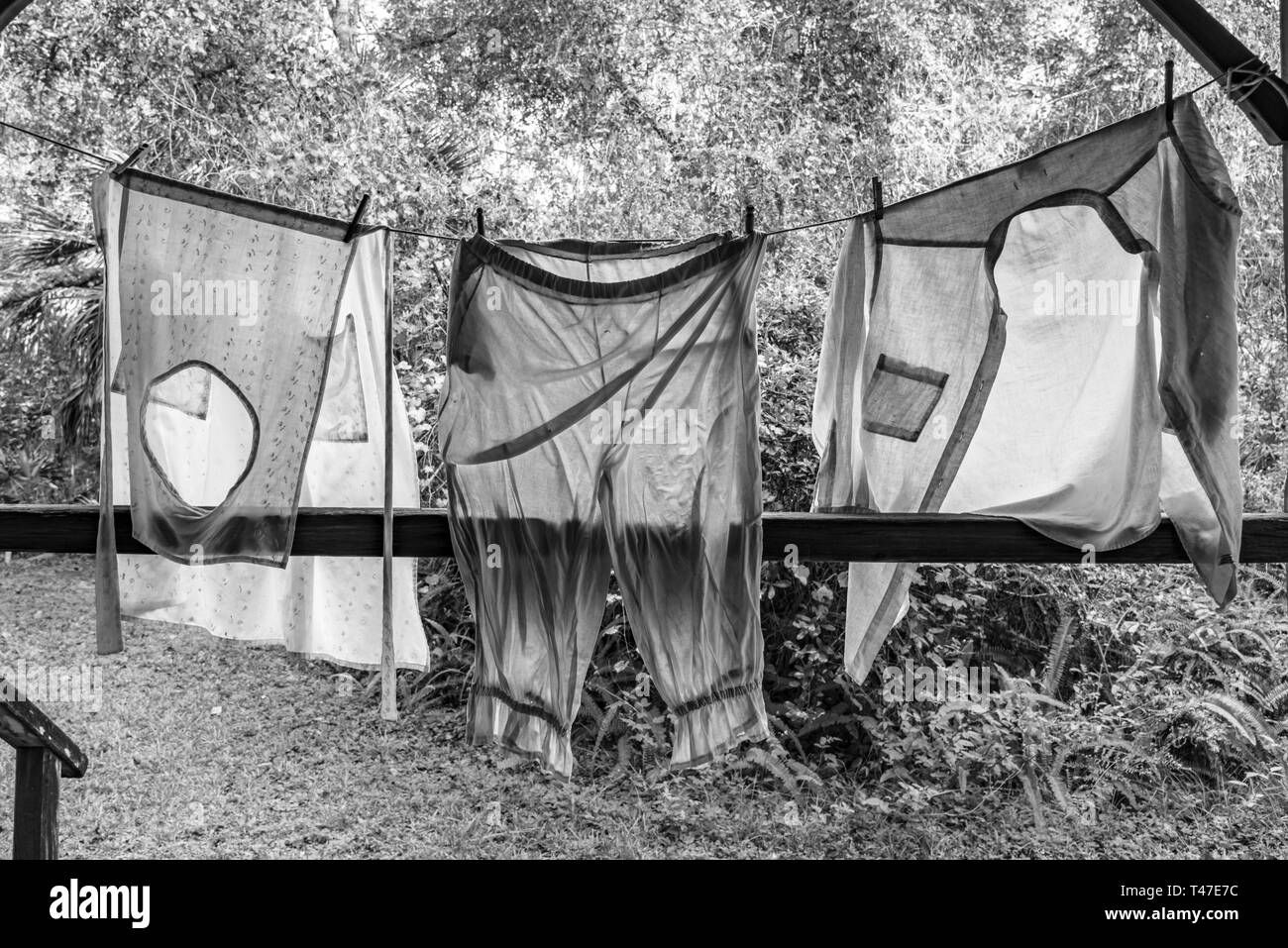 Black and White Photograph of Laundry Hanging on Clothesline Stock Photo