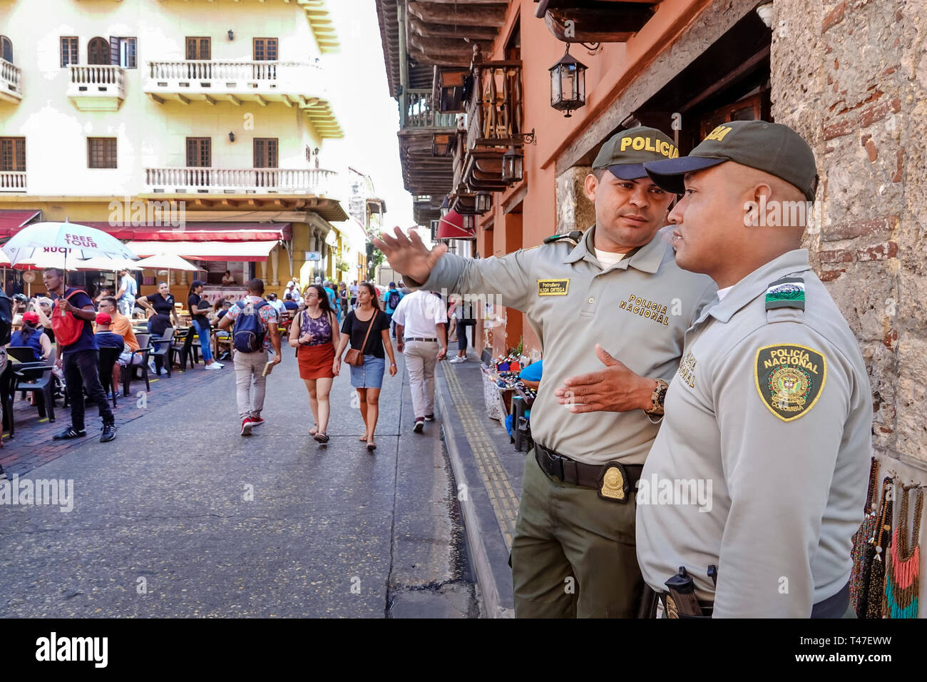 Cartagena Colombia,Hispanic resident,residents,man men male,policia,national police policeman policemen,pedestrians,sidewalk cafe,COL190122070 Stock Photo