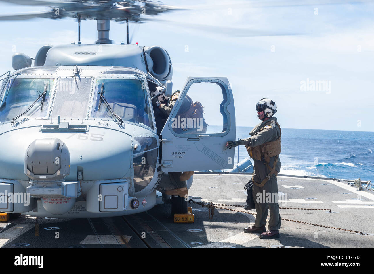 190410-N-DS74-0044 ATLANTIC OCEAN (April 10, 2019) A Pilot boards an MH-60R Sea Hawk helicopter assigned to the “Grandmasters” of Helicopter Maritime Strike Squadron (HSM) 46 aboard the Ticonderoga-class guided-missile cruiser USS Leyte Gulf (CG 55) during flight operations. Leyte Gulf is underway as part of the Abraham Lincoln Carrier Strike Group (ABECSG) deployment in support of maritime security cooperation efforts in the U.S. 5th, 6th and 7th Fleet areas of responsibility. With Abraham Lincoln as the flagship, deployed strike group assets include staffs, ships and aircraft of Carrier Stri Stock Photo