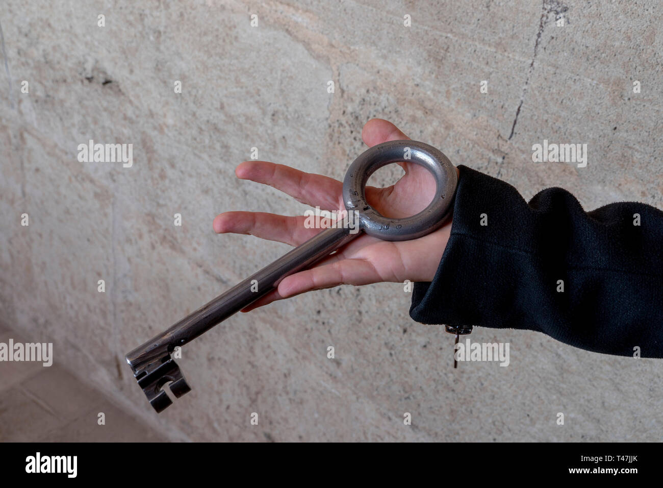hand holding giant iron medieval key detail Stock Photo Alamy