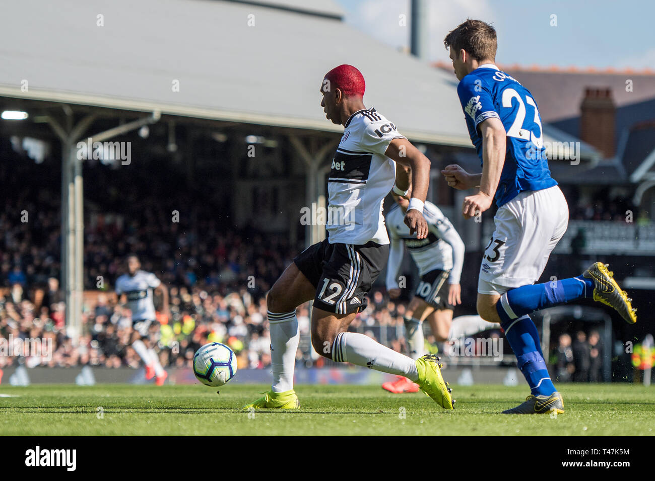 LONDON, ENGLAND - APRIL 13: Ryan Babel of Fulham FC passing ball to his team mate Tom Cairney during the Premier League match between Fulham FC and Everton FC at Craven Cottage on April 13, 2019 in London, United Kingdom. (Photo by Sebastian Frej/MB Media) Stock Photo