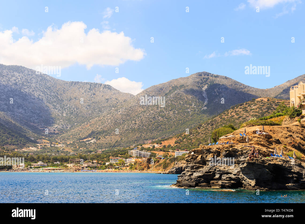 Sea Bay of resort village Bali. Views of mountain, shore, washed by waves and sun loungers. Bali, Rethymno, Crete, Greece Stock Photo