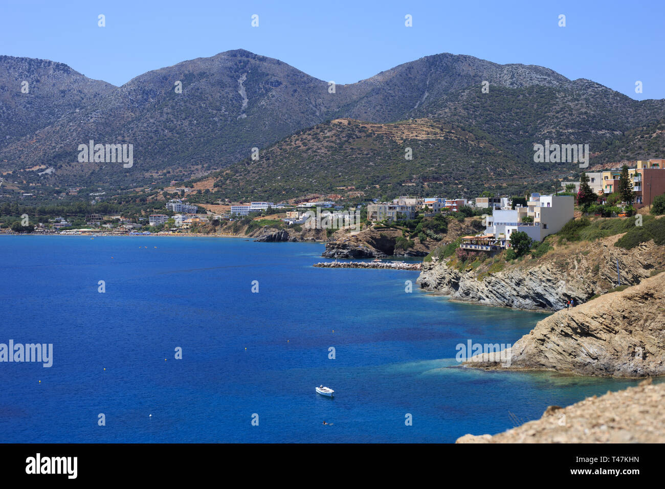 Sea Bay of resort village Bali. Views of mountain, shore, washed by waves and sun loungers. Bali, Rethymno, Crete, Greece Stock Photo