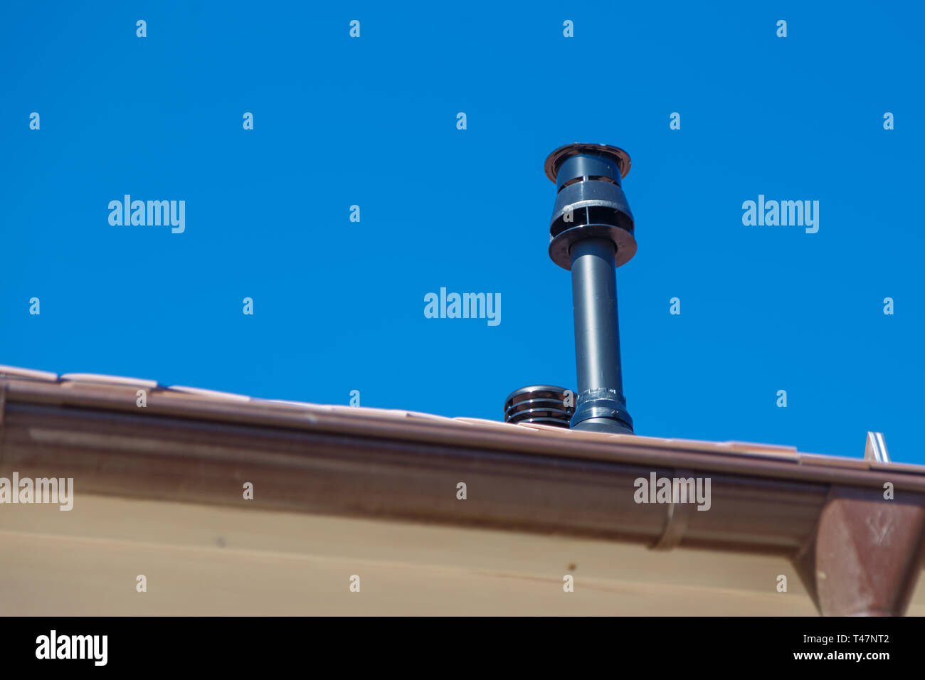 modern chimney pipe on roof Stock Photo Alamy