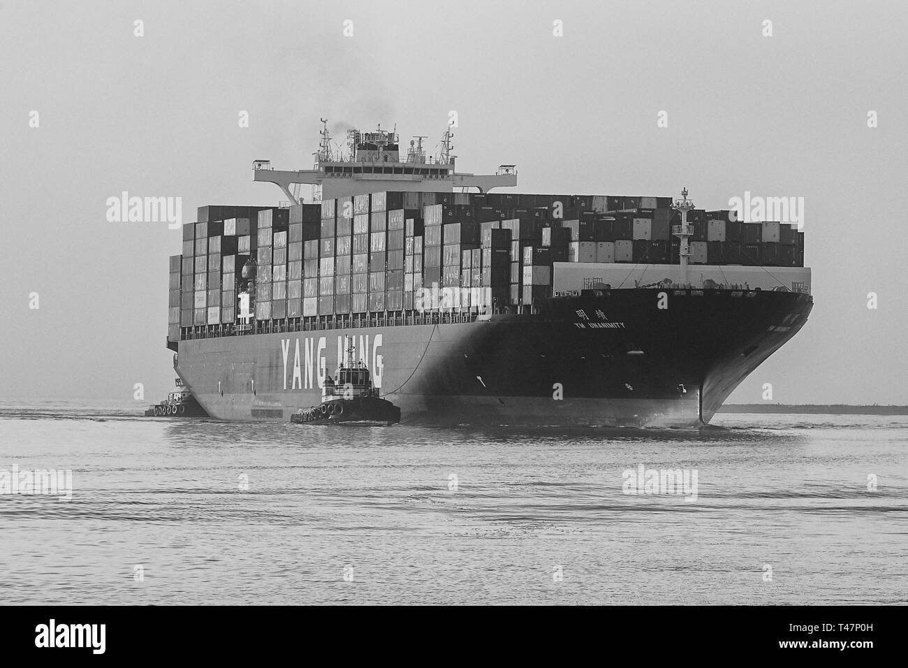 Black And White Photo Of The Container Ship, YM UNANIMITY, Entering The Los Angeles Main Channel, Steaming To The Los Angeles Container Terminal, USA Stock Photo