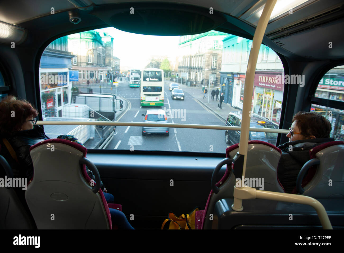 Two big woman in the Edinburgh double decker bus looking out of the window. Stock Photo