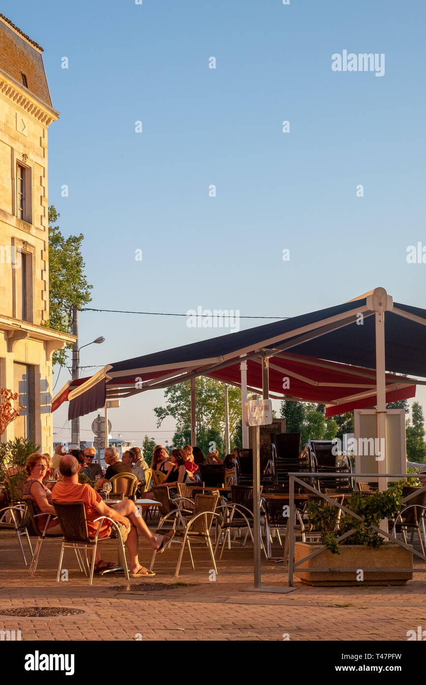 People sit at an outdoor restaurant in Blaye, France, Stock Photo