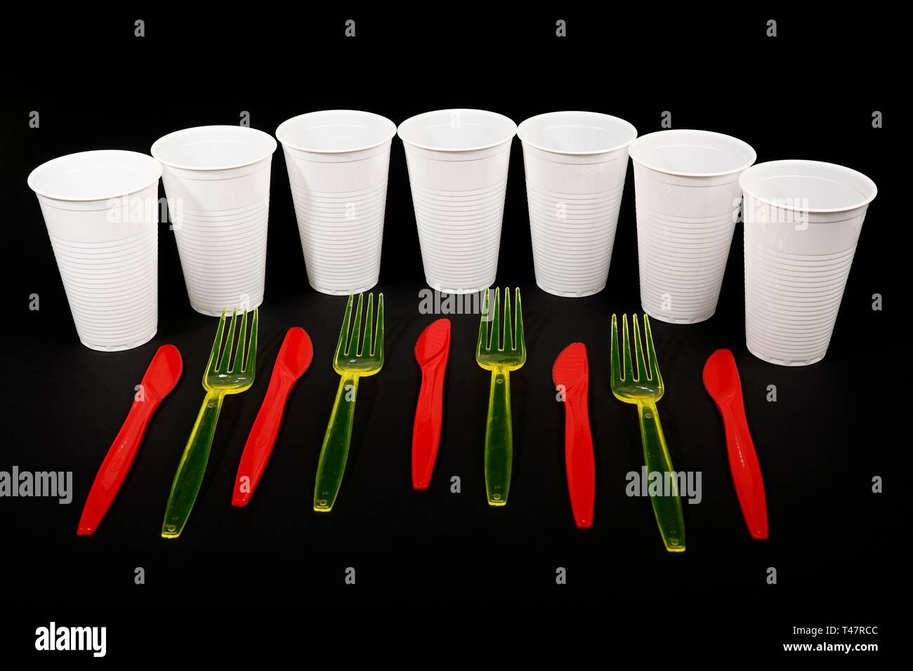 Red and yellow plastic cutlery, plastic knives, plastic forks, white plastic cups, plastic waste, Germany Stock Photo