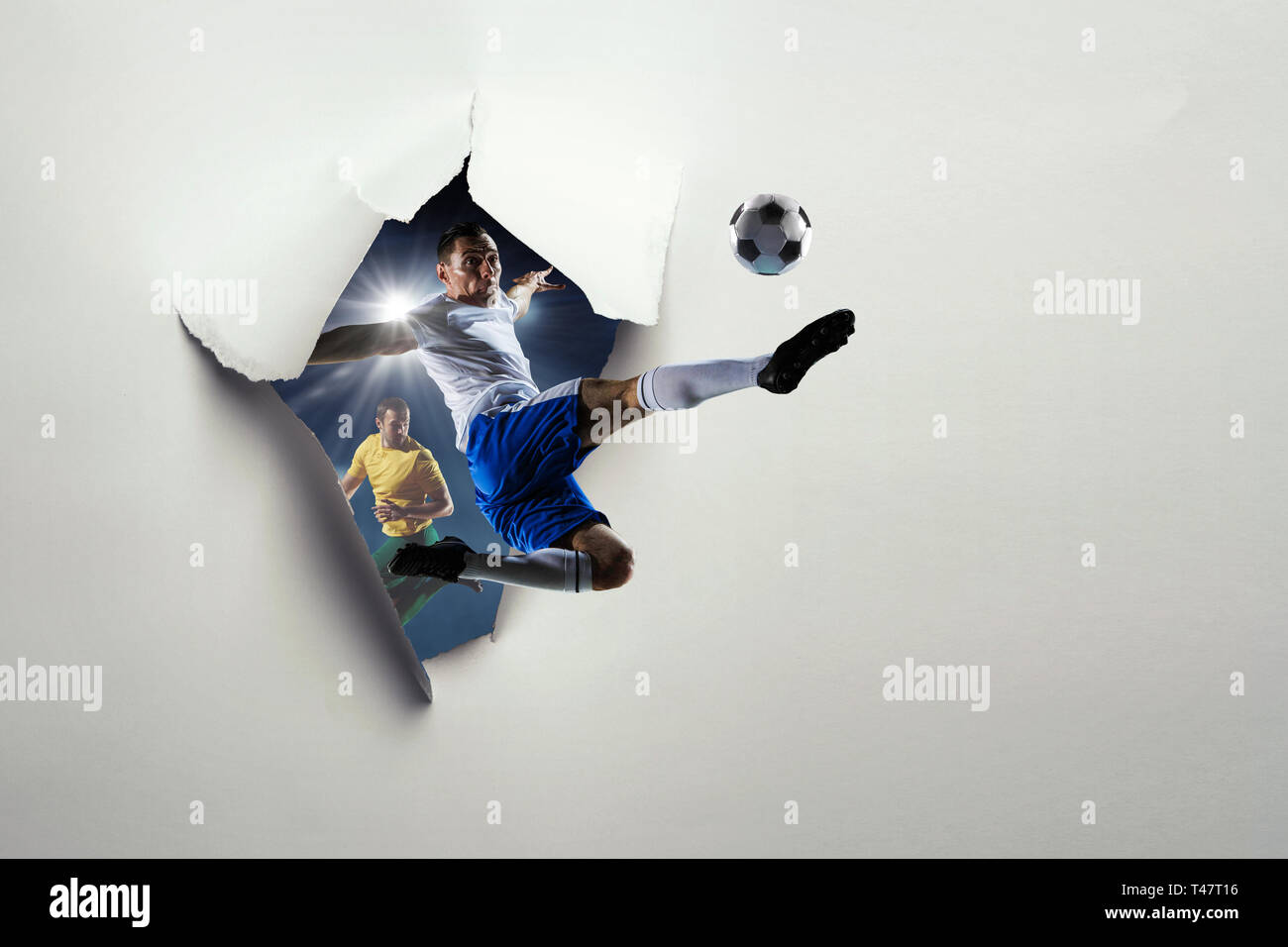 Paper breakthrough hole effect and soccer players. Mixed media Stock
