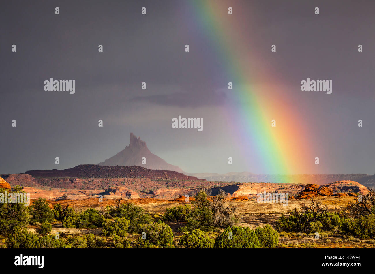 A rainbow over South Six-Shooter Peak in South Eastern Utah as seen from Canyonland National Park during a rain storm, USA. Stock Photo