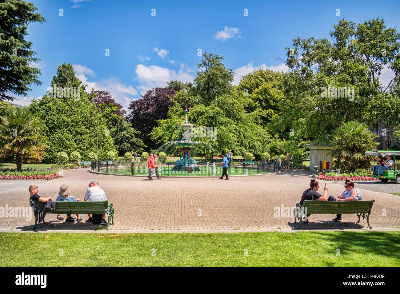 8 January 2019: Christchurch, New Zealand - People sitting and walking near the Peacock Fountain in Christchurch Botanic Gardens. Stock Photo