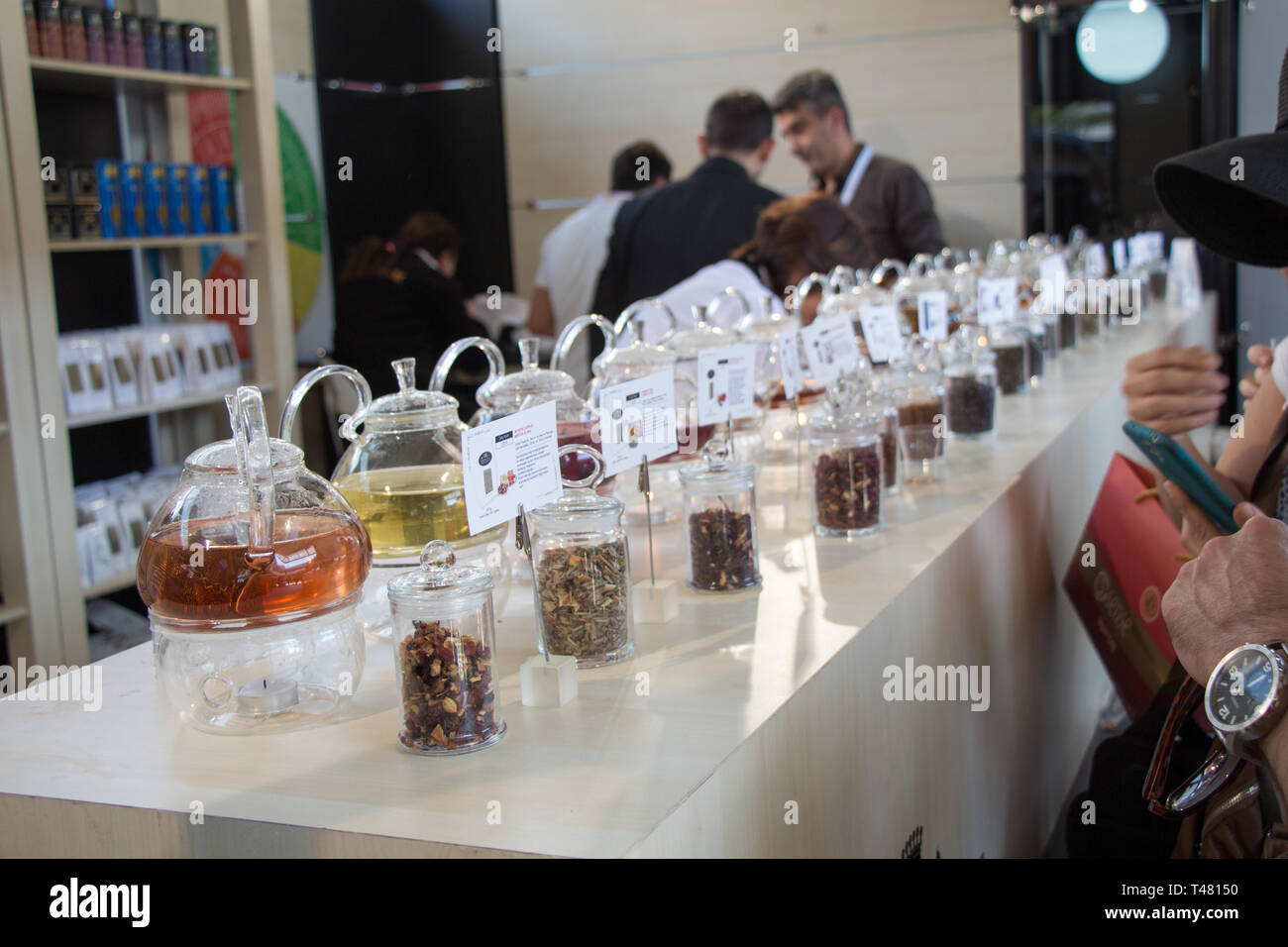 Various flavors of different herbal teas in glass teapots Stock Photo