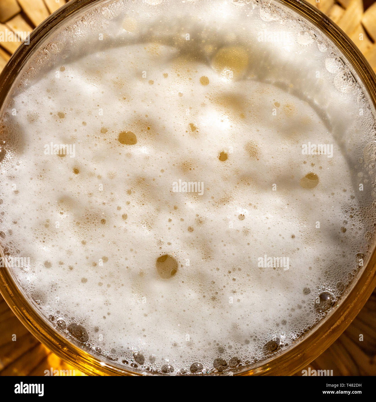Beer in a glass with frothy foam and bubbles. Beer foam. View from the ...
