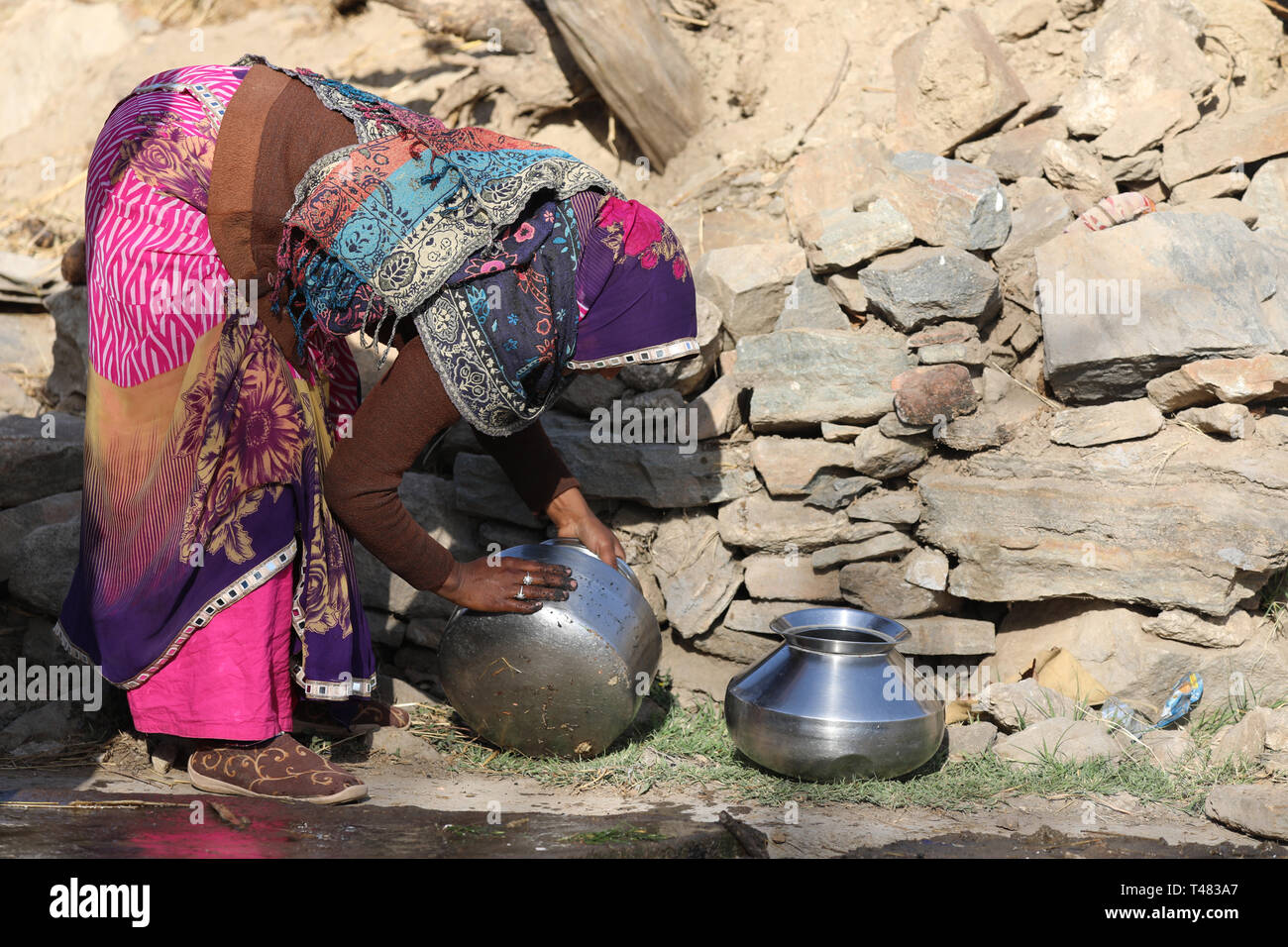 Woman Ranjasthan washing bowls for Water Stock Photo