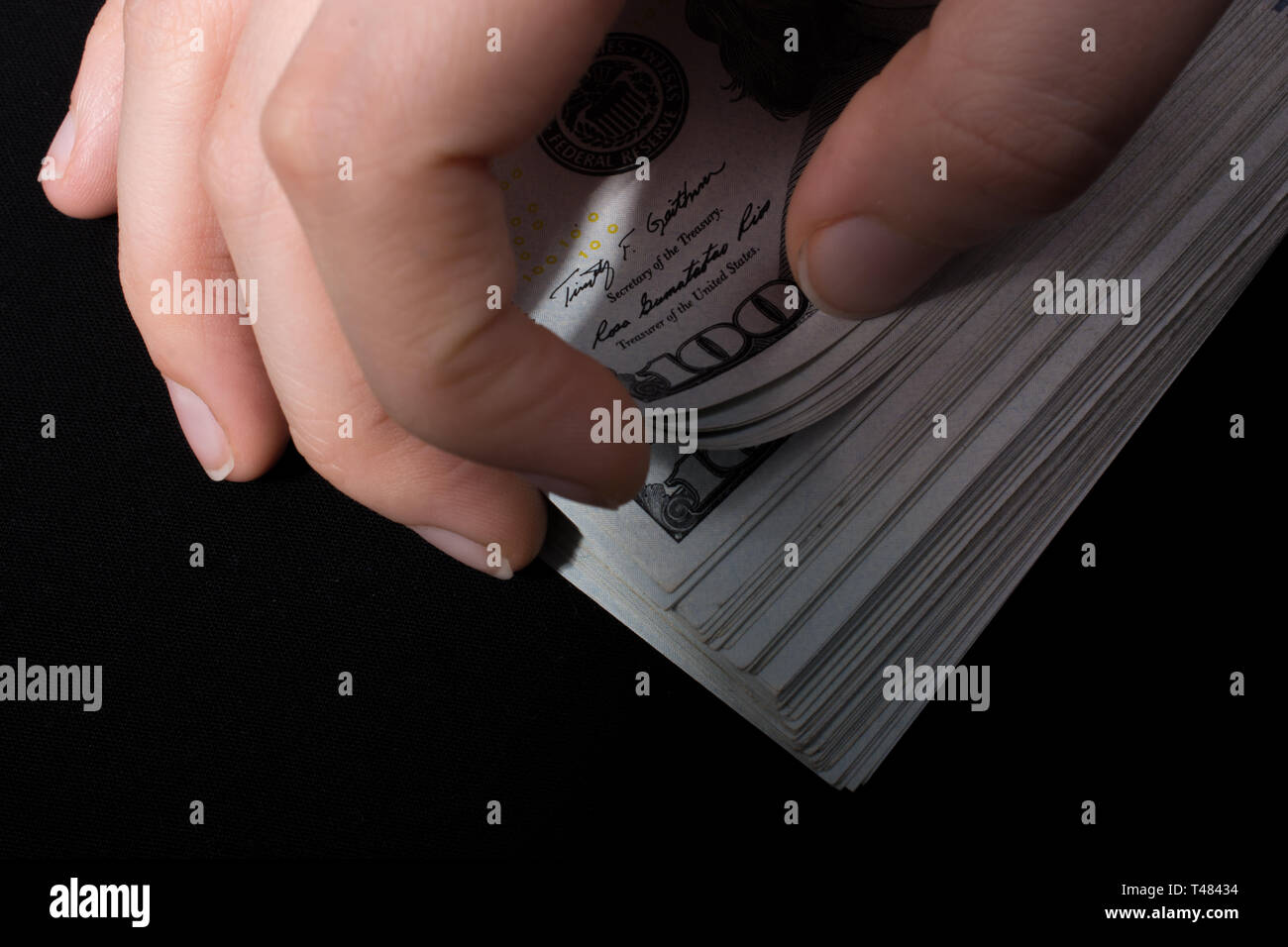 Hand holding American dollar banknotes isolated on white background ...