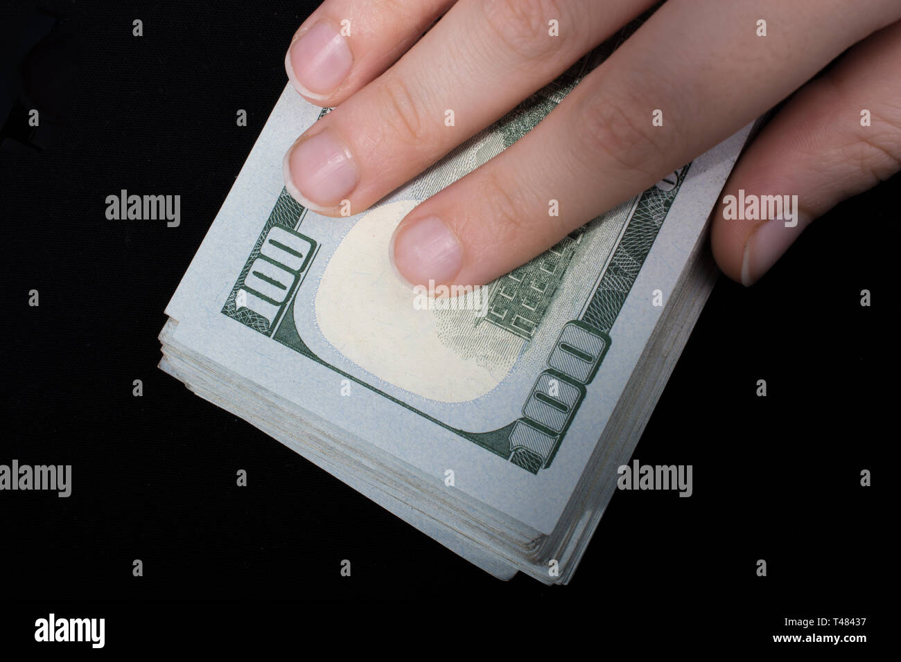 Hand holding American dollar banknotes isolated on white background ...