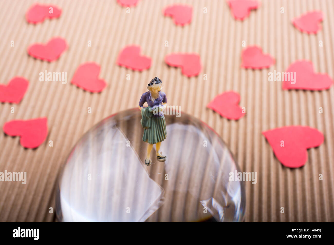 Woman figurine and Love concept with red paper hearts Stock Photo - Alamy