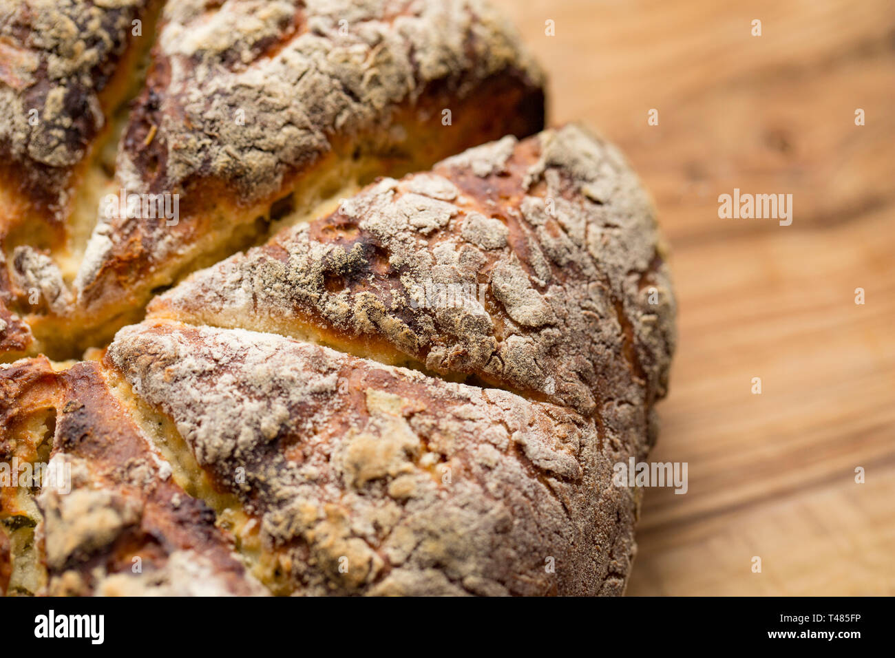 Home cooked soda bread that has been made with olive oil, salt, baking soda, chopped rosemary