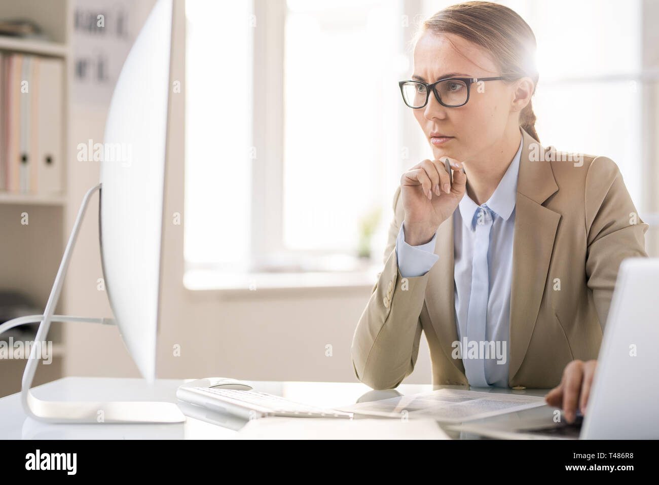 Concentrated lady analyzing documents Stock Photo