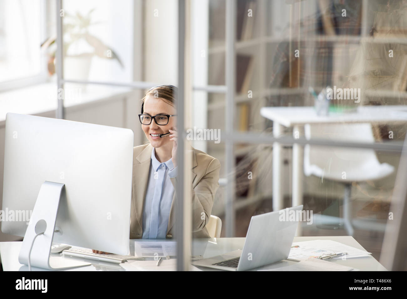Positive customer service operator answering question of client Stock Photo