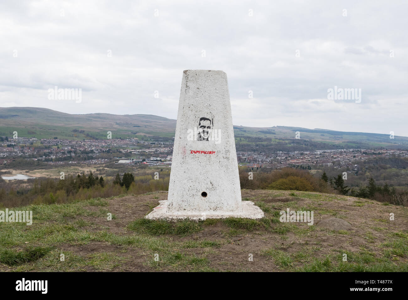 white trigpoint with stencil graffiti - Castle Hill Hillfort, nr Bar Hill Fort, Antonine Wall,  Twechar, East Dunbartonshire, Scotland, UK Stock Photo