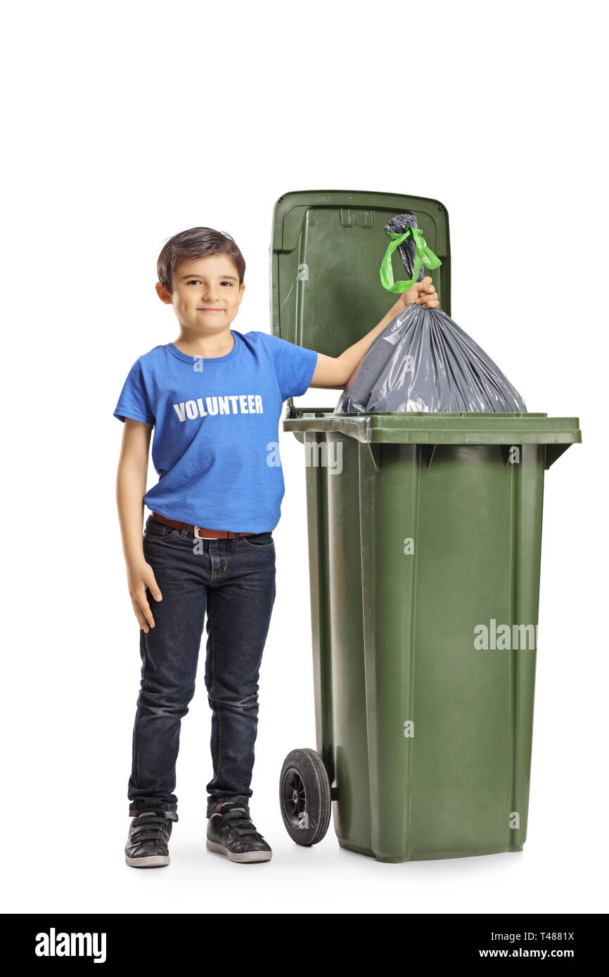 Full length portrait of a boy volunteer throwing a waste bag into a bin isolated on white background Stock Photo