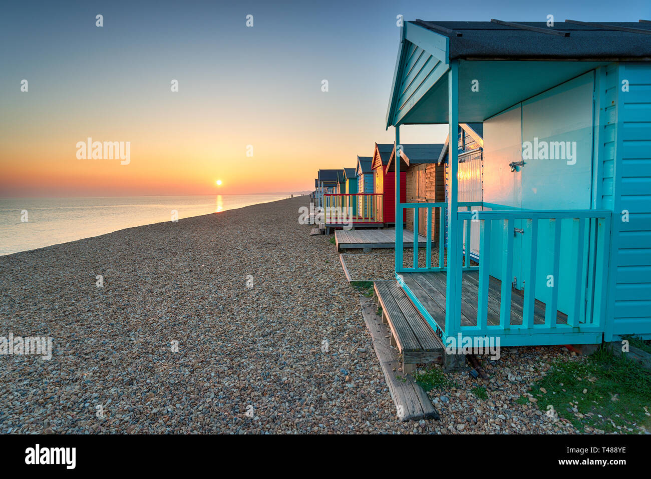 Stunning sunset over seaside beach huts at Milton on Sea on the Hampshire coastline Stock Photo