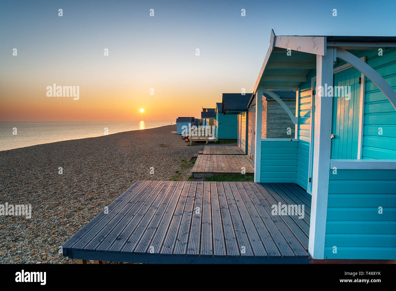Sunset over beach huts at Milford on Sea in Hampshire Stock Photo