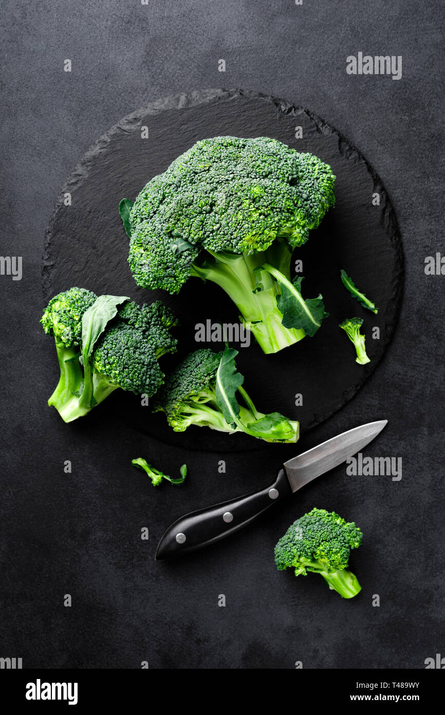 Fresh broccoli florets on black background, top view Stock Photo