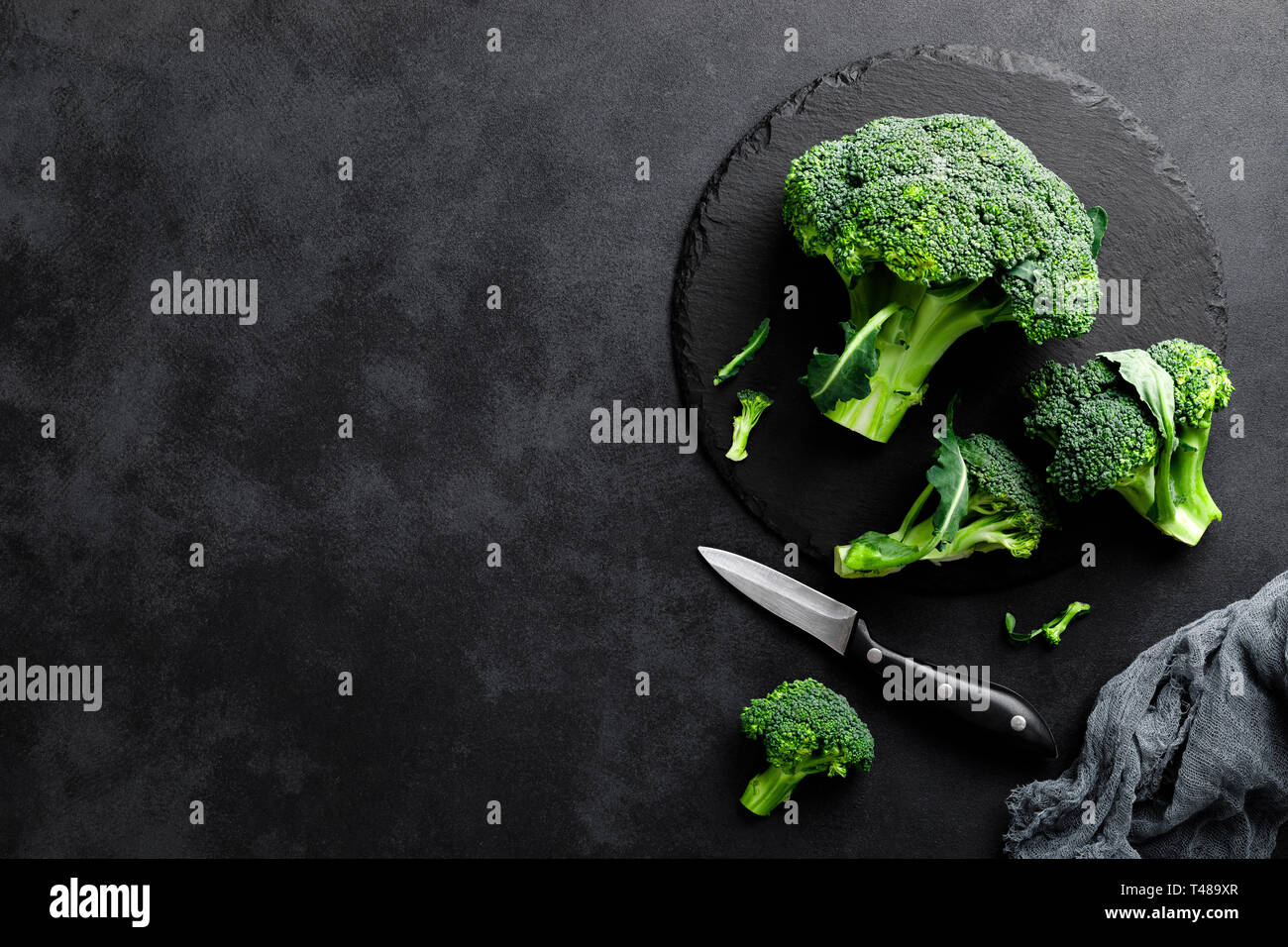 Fresh broccoli florets on black background, top view Stock Photo