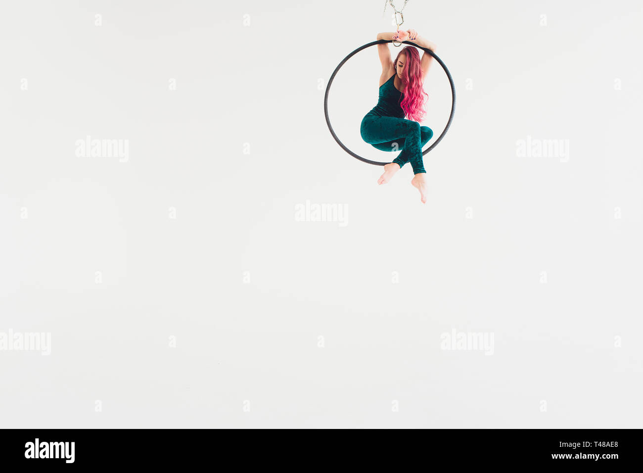 Aerial acrobat in the ring. A young girl performs the acrobatic ...