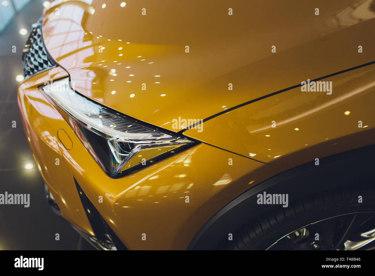 Car detailing series Clean headlights of yellow sports car Stock Photo