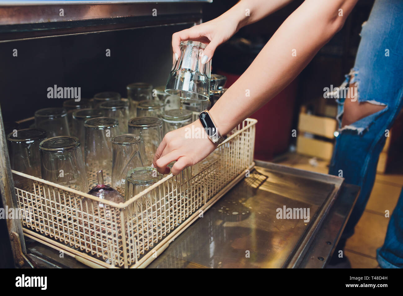 Discharging clean and shiny glasses from the dishwasher Stock Photo Alamy