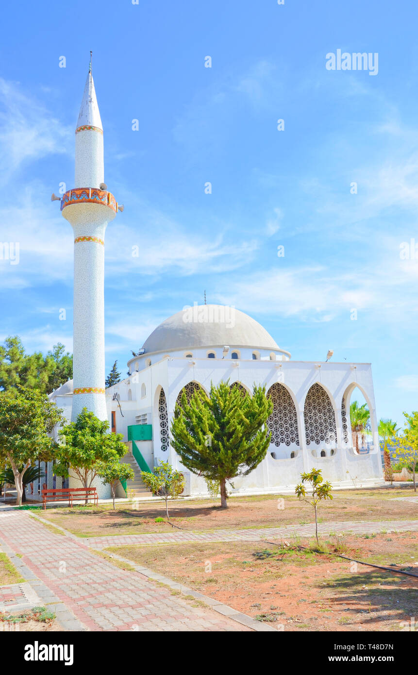 Islamic mosque in Dipkarpaz, Karpas Peninsula, Northern Cyprus taken on a sunny day with blue sky above. Captured on a vertical picture. Stock Photo