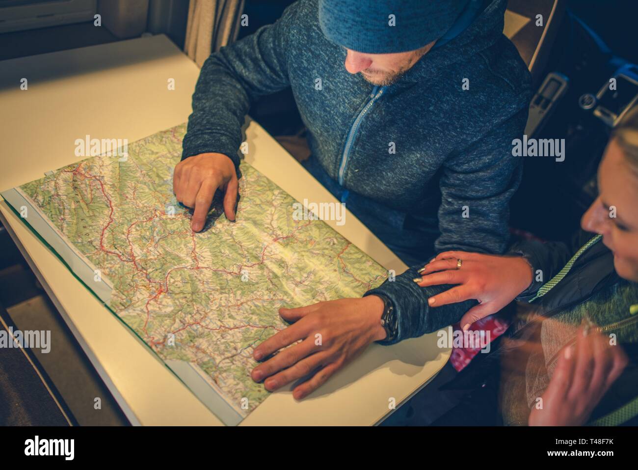 Caucasian Young Family Planning - Caucasian Young Family Planning Road Trip Taking Look On The Local Map Inside The Camper Van T48F7K 