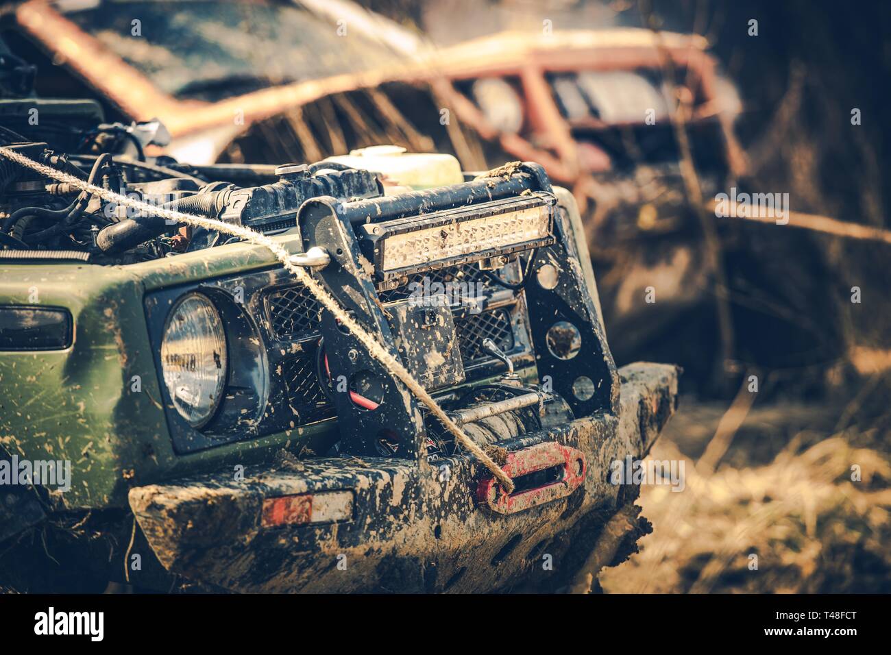 Off Road Expedition. Two Dirty Sport Utility Vehicles Covered by Mud. Motorsport Theme. Stock Photo