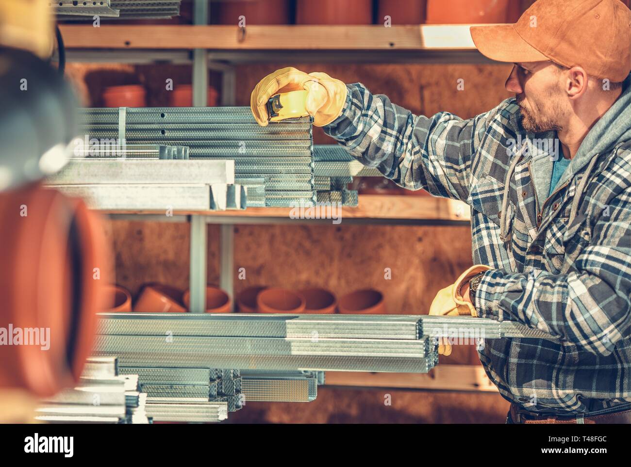 Caucasian Construction Contractor Looking For the Right Steel Framing Elements For the Job. Industrial Theme. Stock Photo