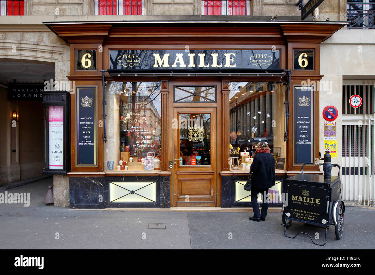 Boutique Maille, 6 Place de la Madeleine, Paris, France. exterior storefront of a mustard boutique with different flavored mustard on tap. Stock Photo