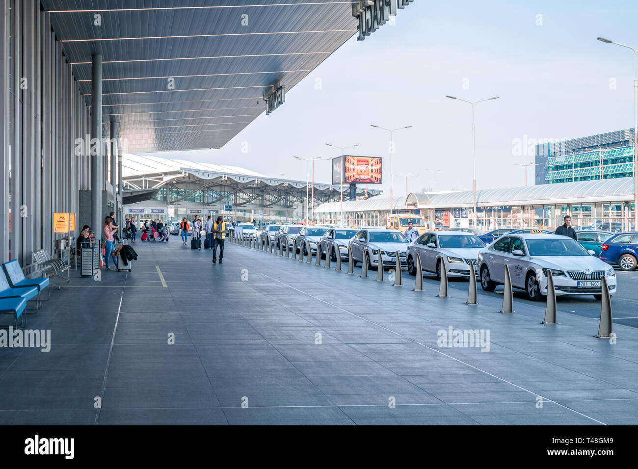 The taxi stand in front of Prague International Airport on a bright sunny day with lots of Taxis waiting outside Stock Photo