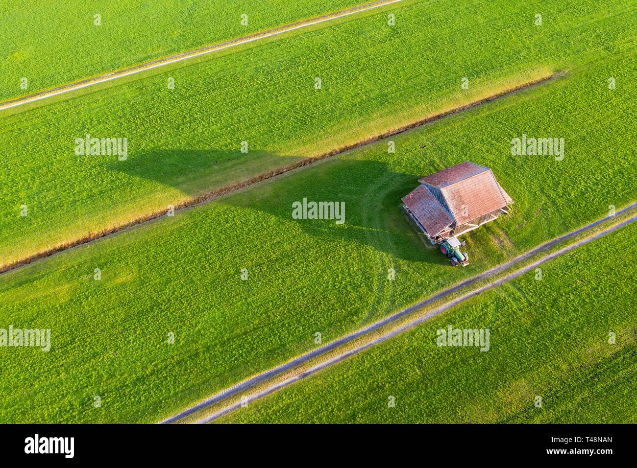 Meadows with barn and tractor, mercenary moss near Schlehdorf, drone shot, Upper Bavaria, Bavaria, Germany Stock Photo